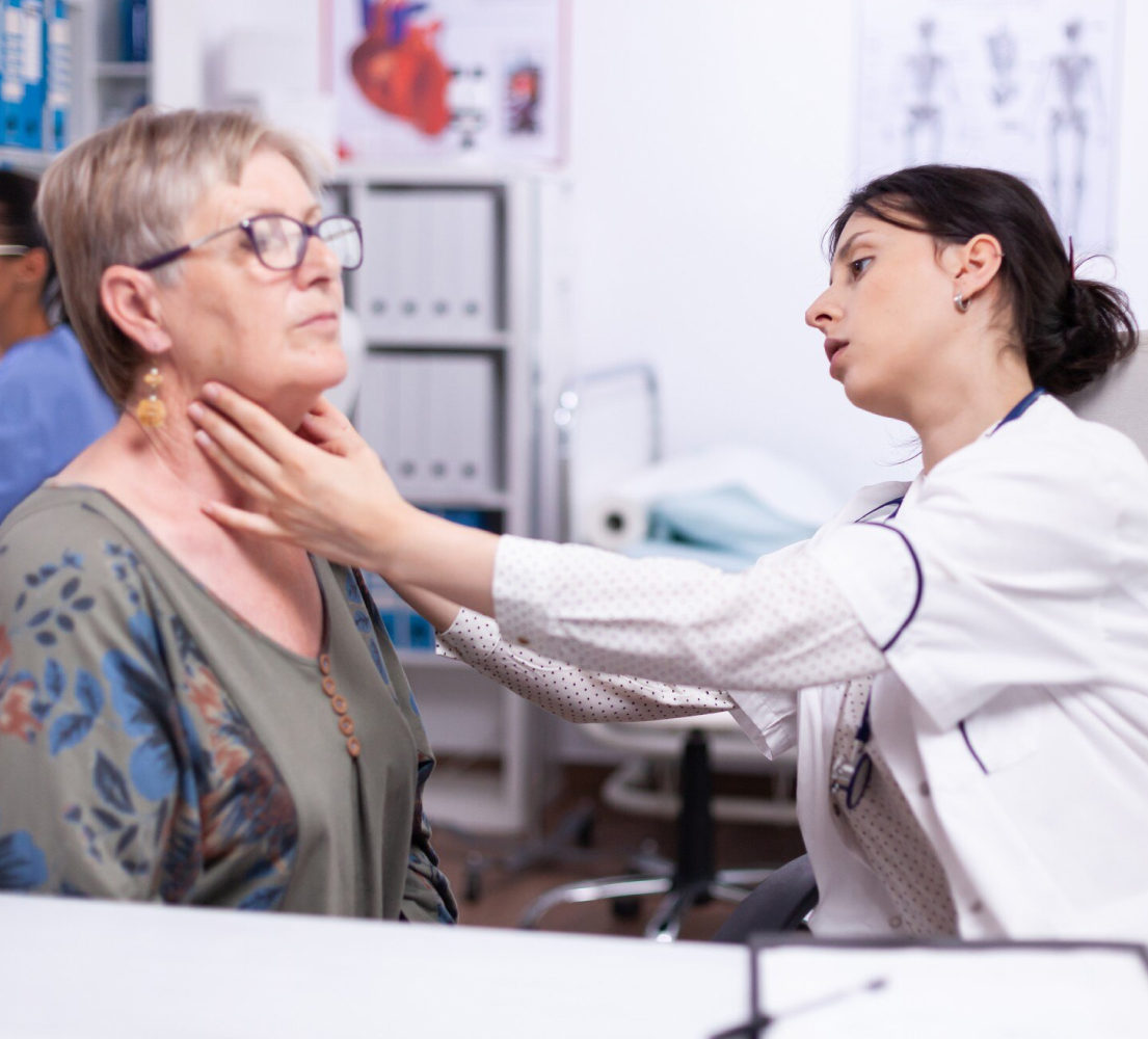 Endocrinologist examining patient with thyroid issue using AI Scribe for Endocrinologists support.