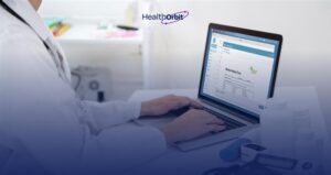 Doctor reviewing digital medical records on laptop, showcasing AI-driven medical billing accuracy.